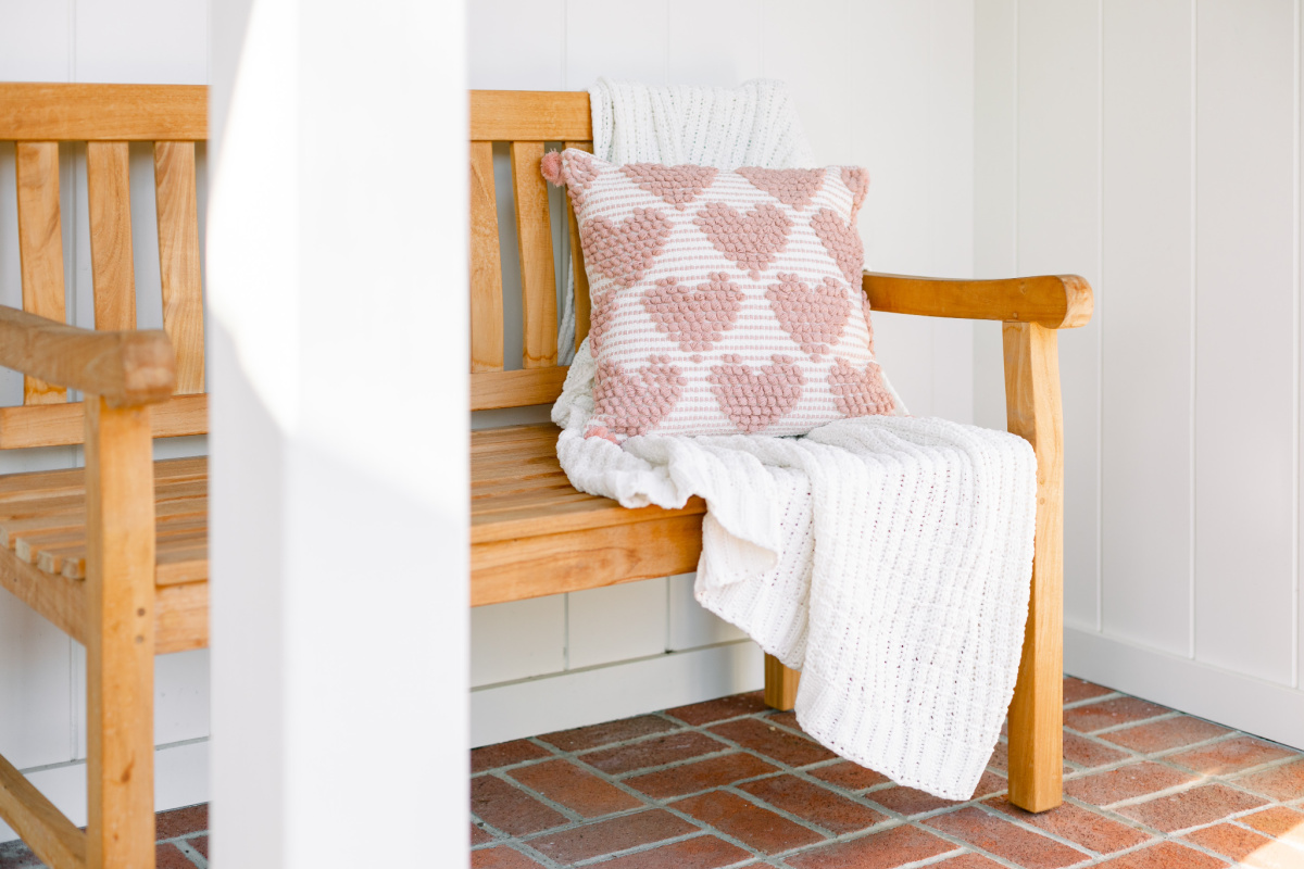 Teak bench with valentine pillow