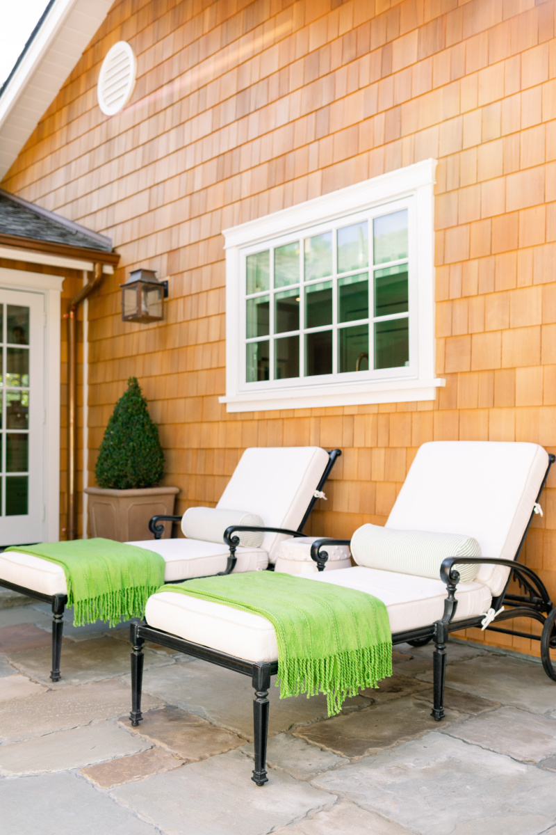 Chaise lounge chairs with green throw blankets