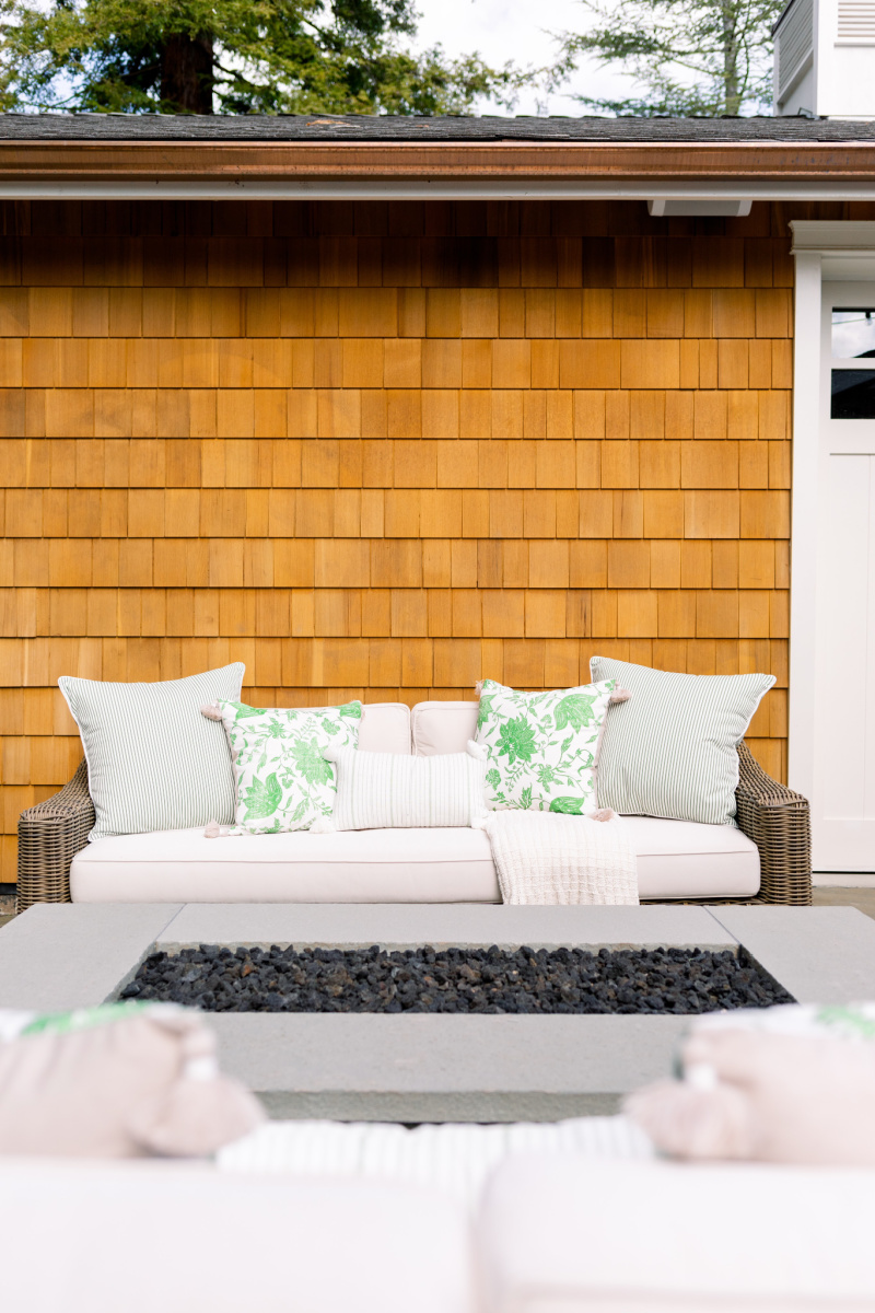 Outdoor sofa with green and white pillows