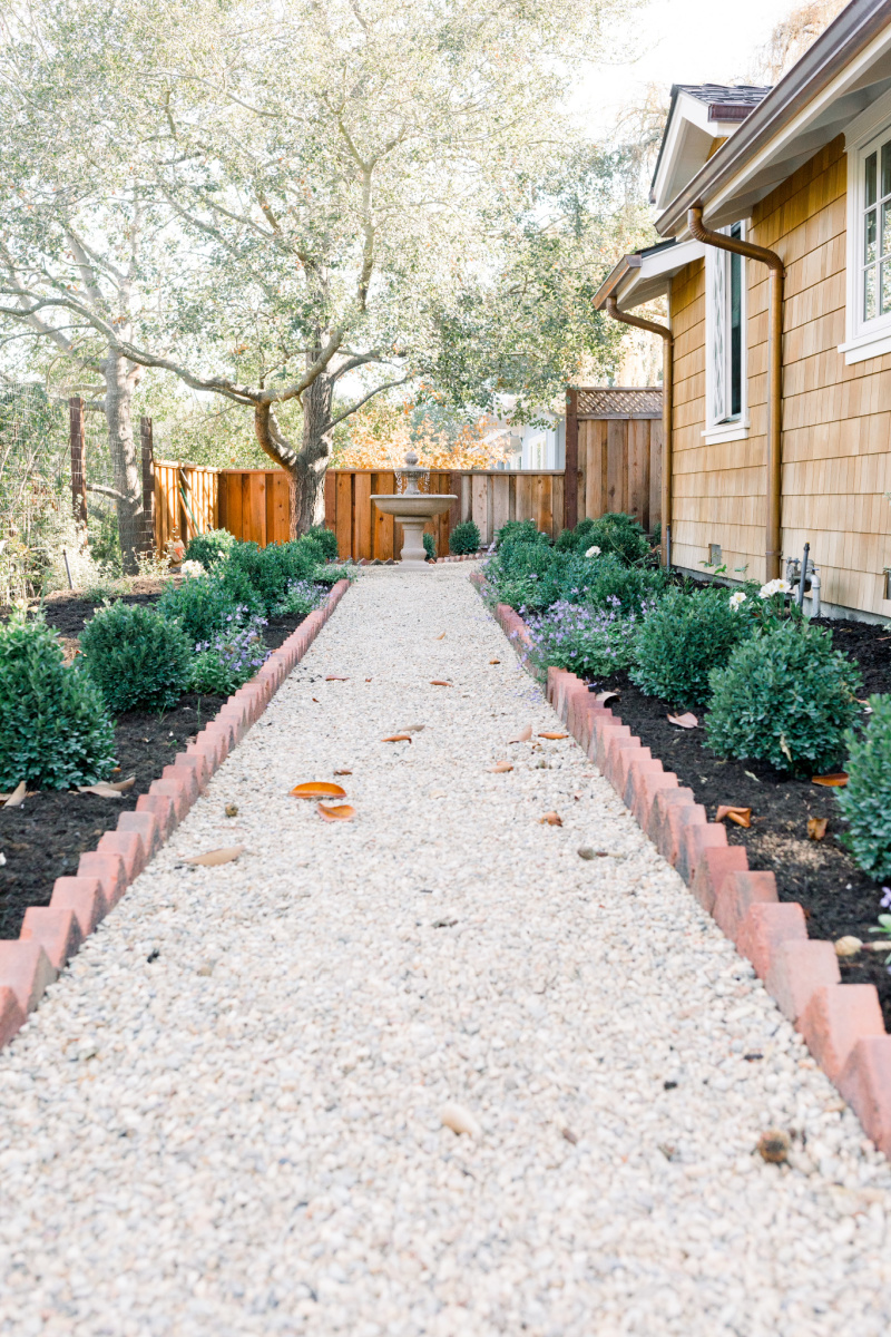 Garden gravel path with brick border and boxwoods