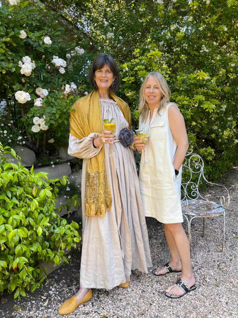 Women in garden sipping tea