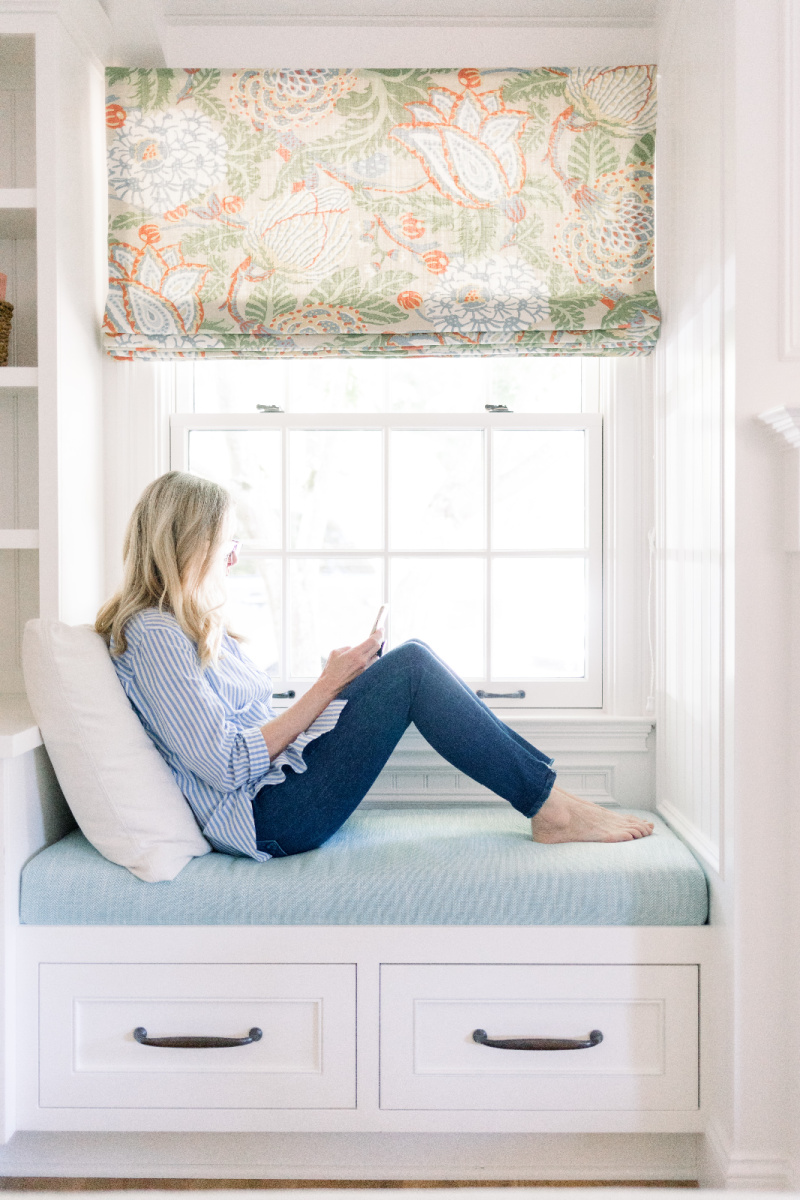 Woman reading in window seat