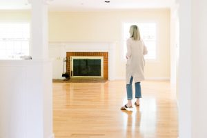 Woman looking into empty living room before renovation