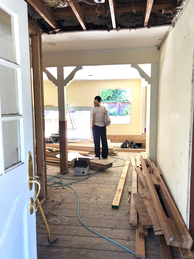 Woman standing in demolished living room