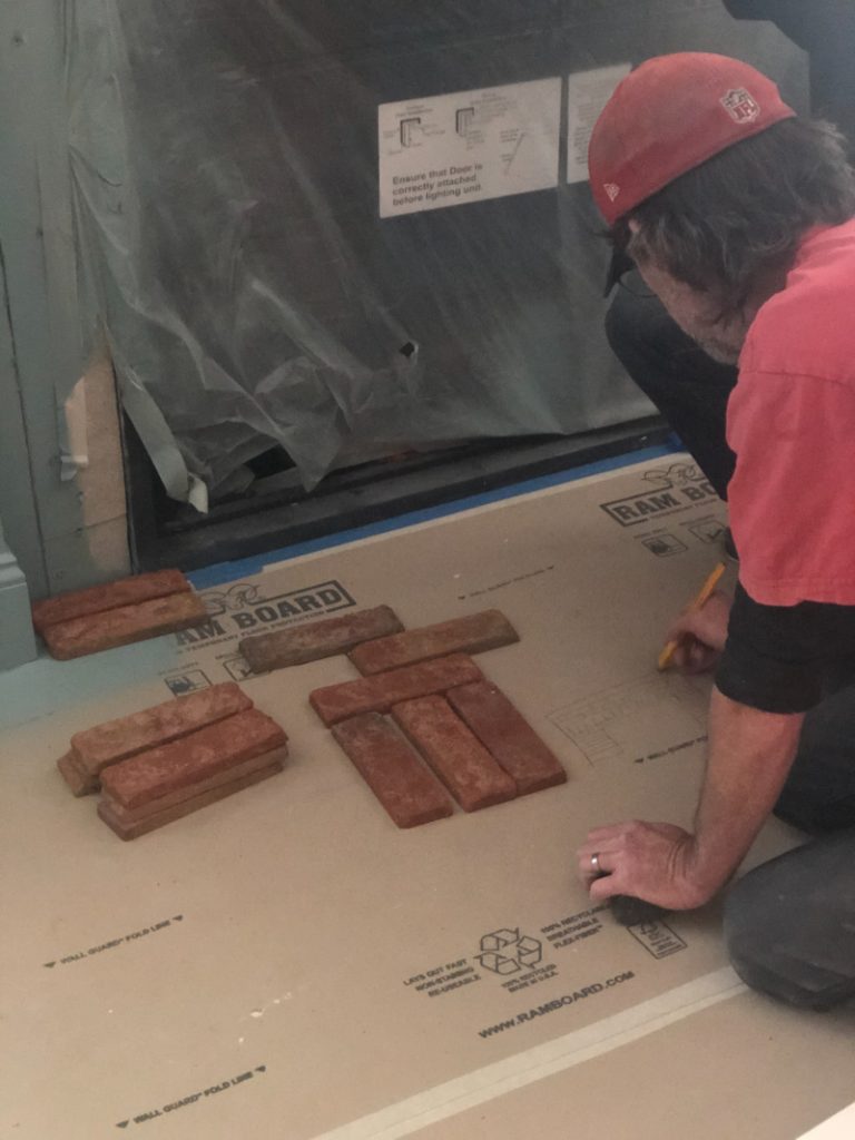 Man working on fireplace brick