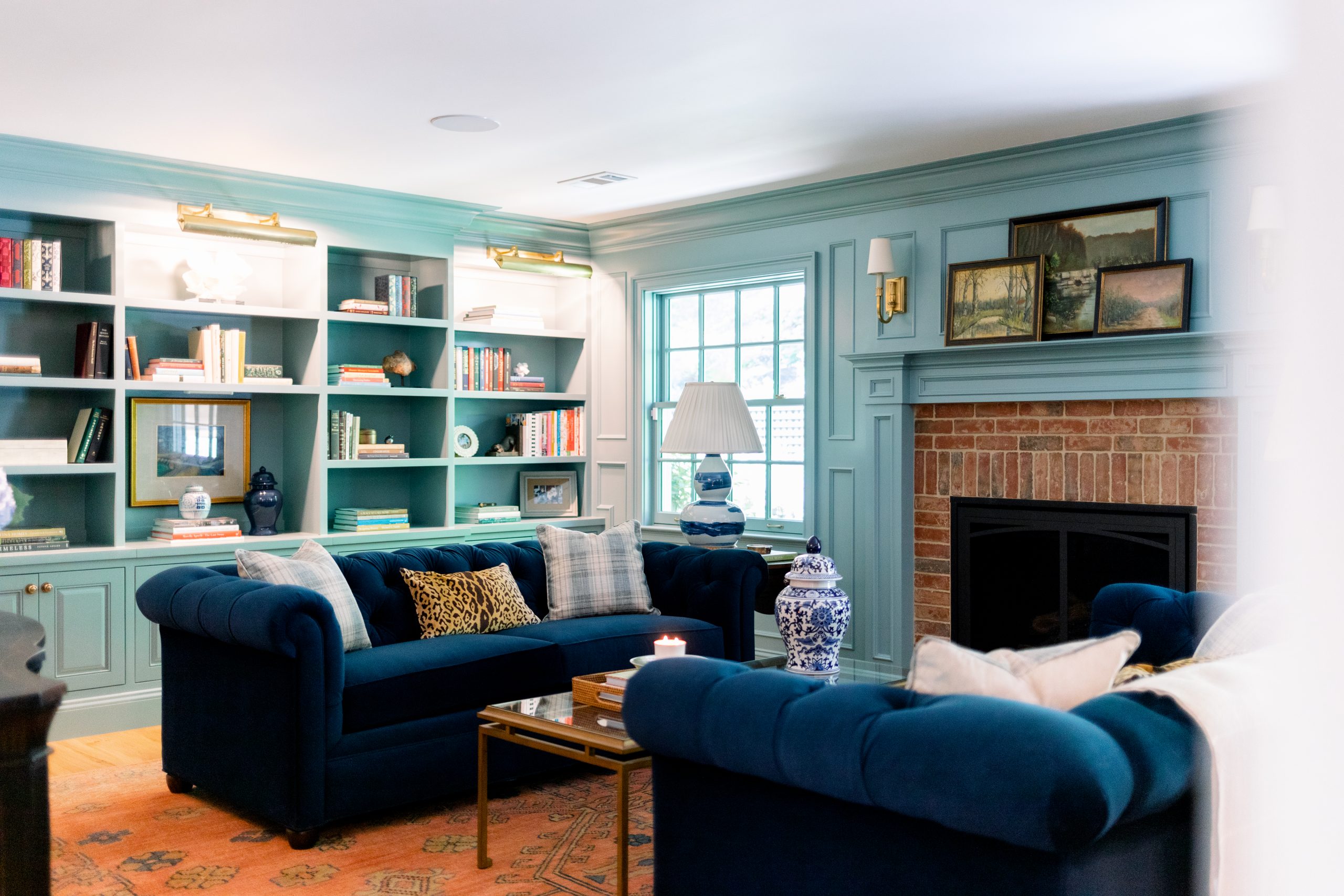 Home Library with blue velvet sofas and book shelves