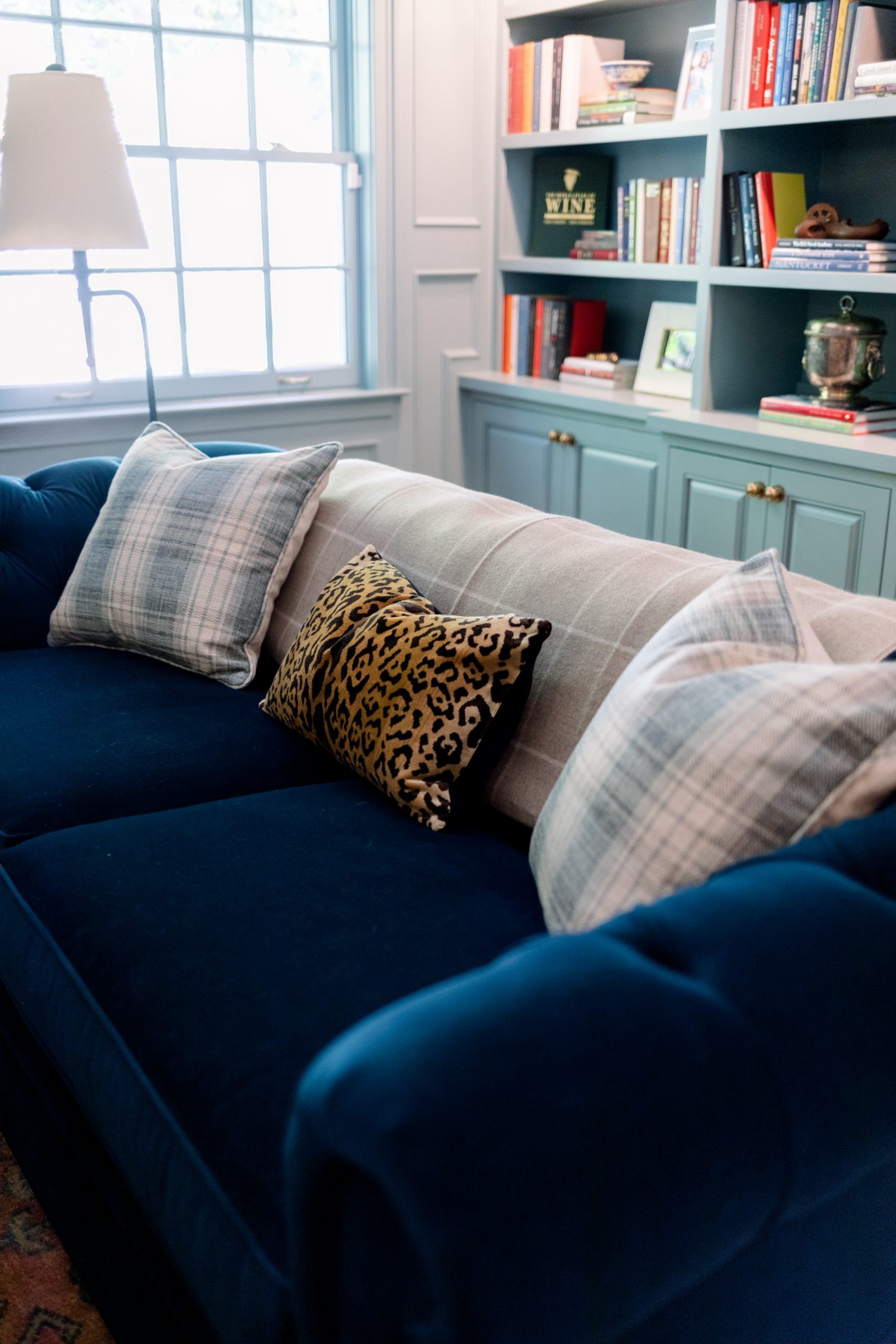Blue Velvet Sofa with Plaid and Leopard Print pillows