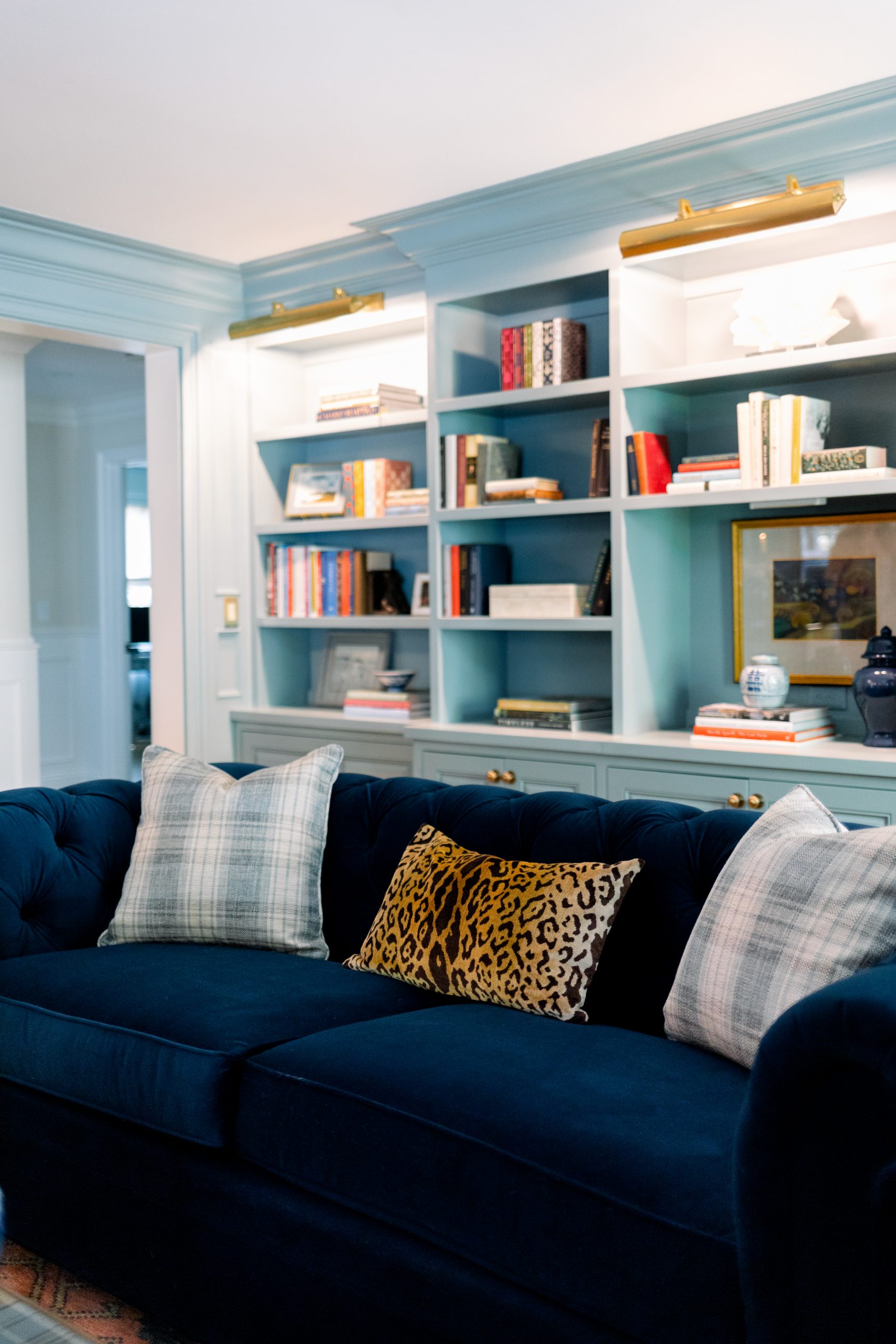 Blue velvet sofa and book cases