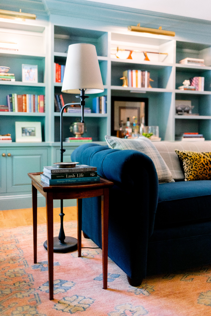 Blue velvet sofa and side table and lamp