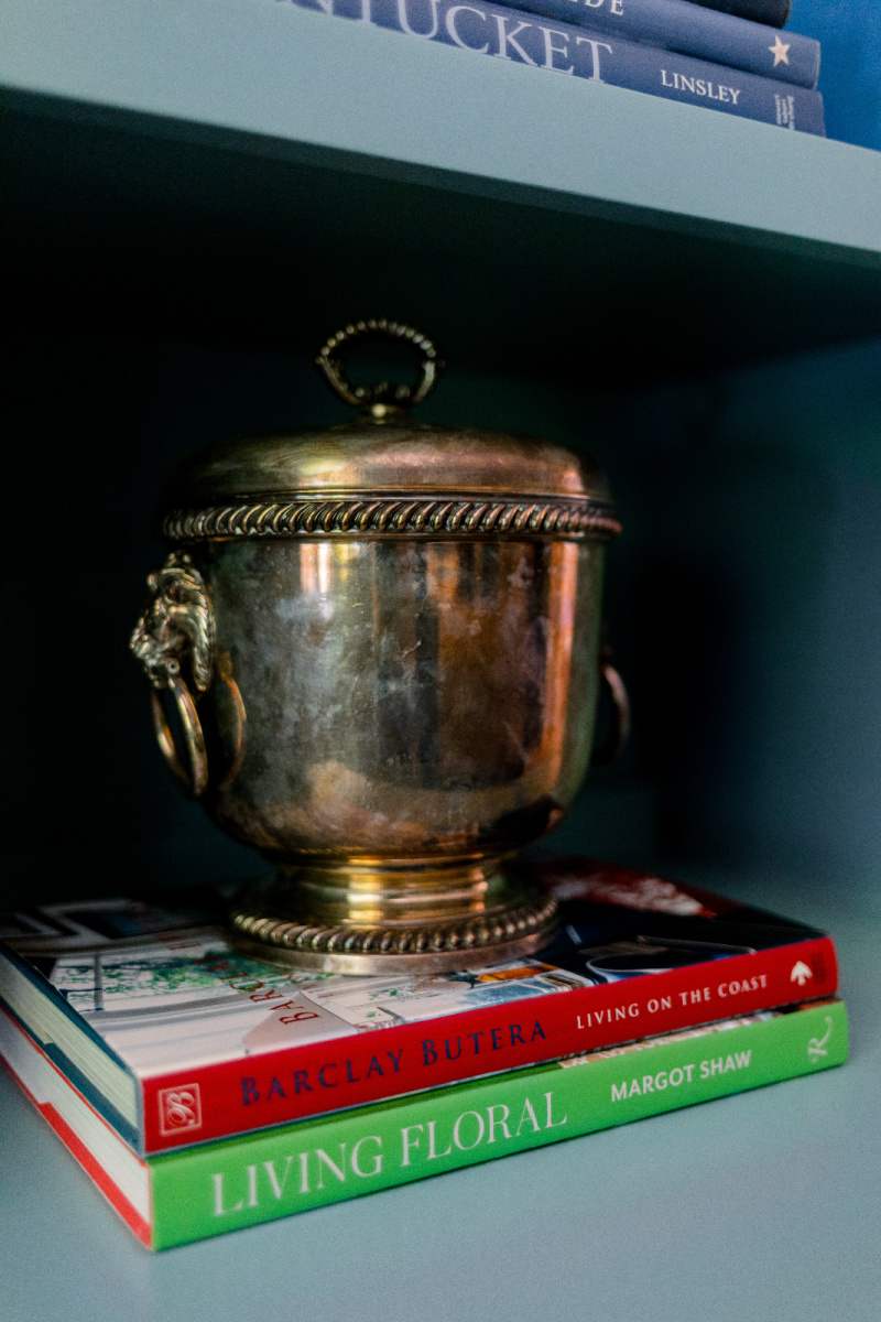 Silver ice bucket sitting on books