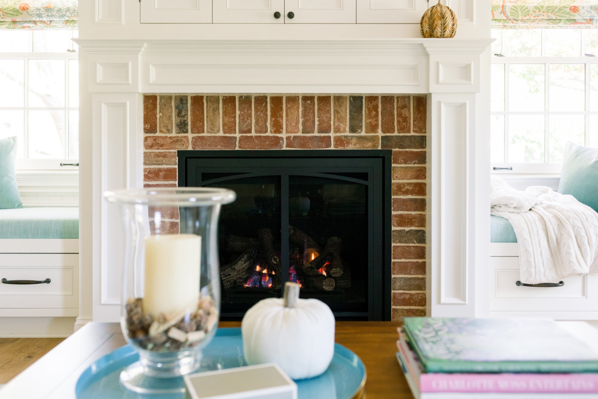 Fireplace mantle and coffee table decorated for fall