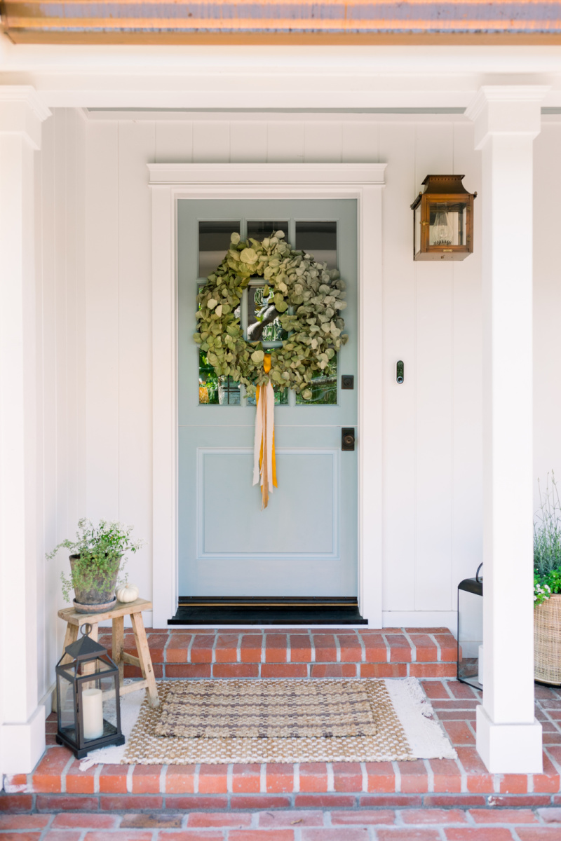 Blue Dutch Door with eucalyptus wreath and fall decor