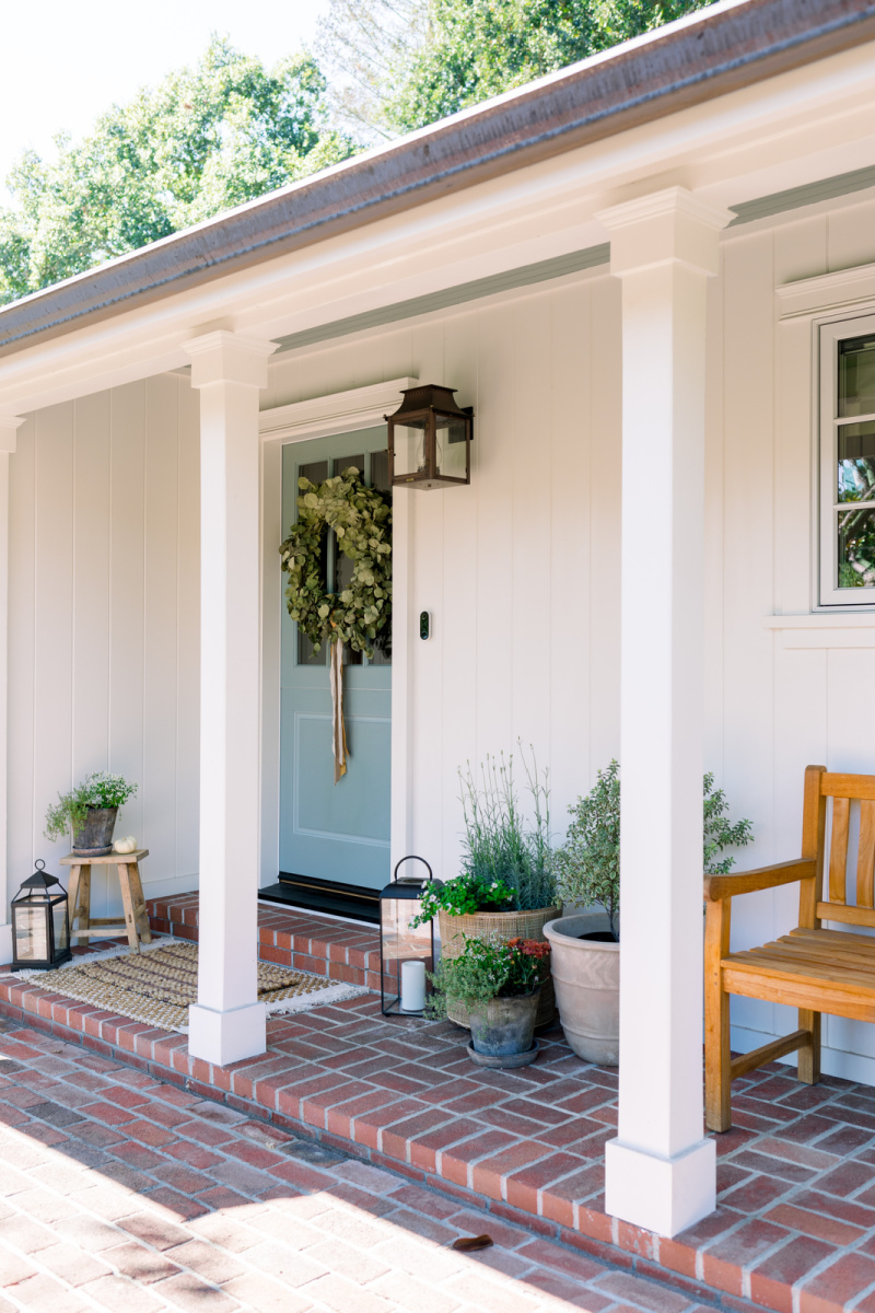 Front Porch and blue door decorated or fall