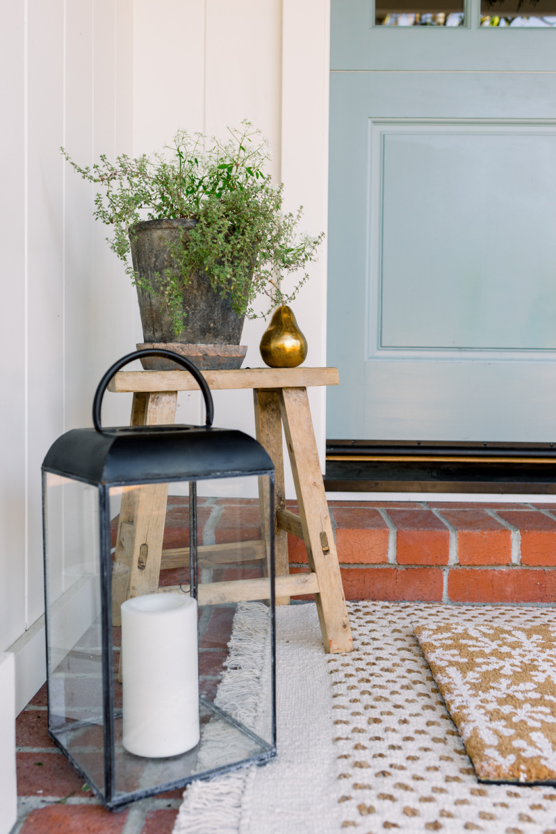 Holiday porch lantern, bench and pear