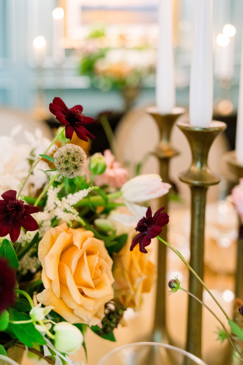 Brass candlesticks and autumnal flowers