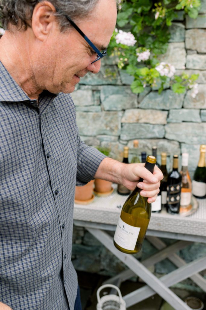 Man opening wine bottle