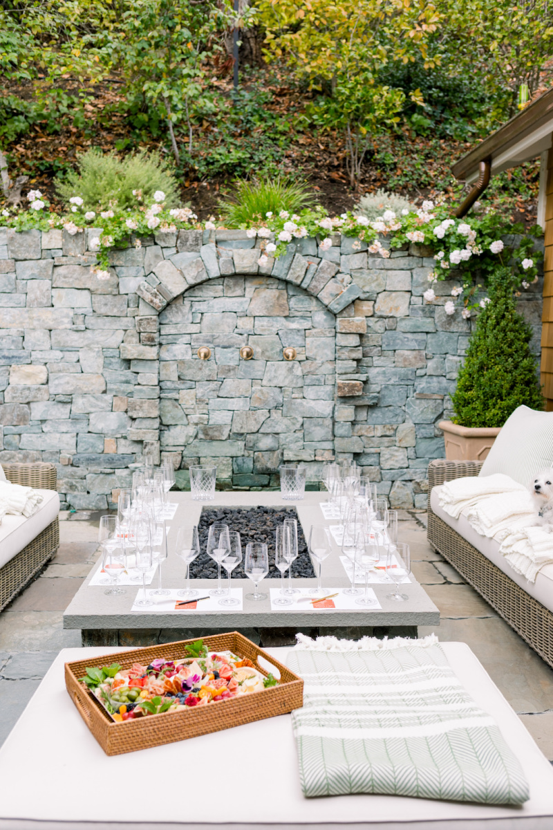 Wine tasting around firepit and water feature