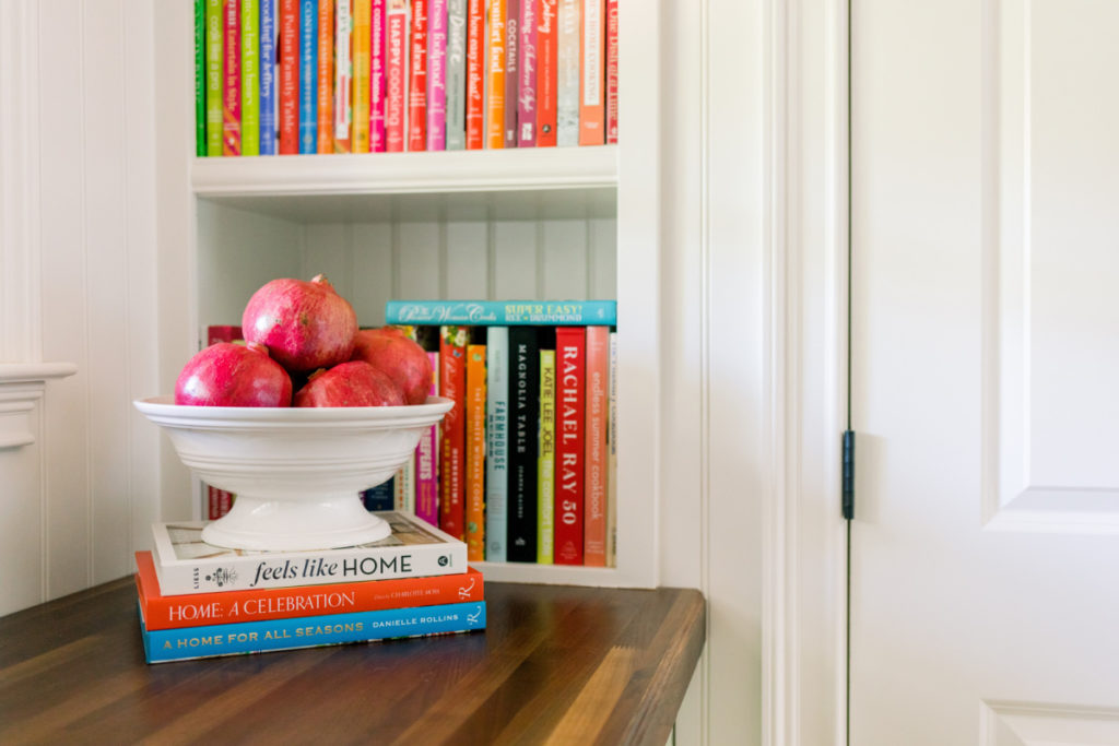 Books and bowl of pomegranate