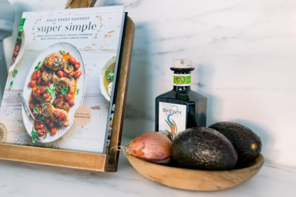 Cookbook on stand and olive oil