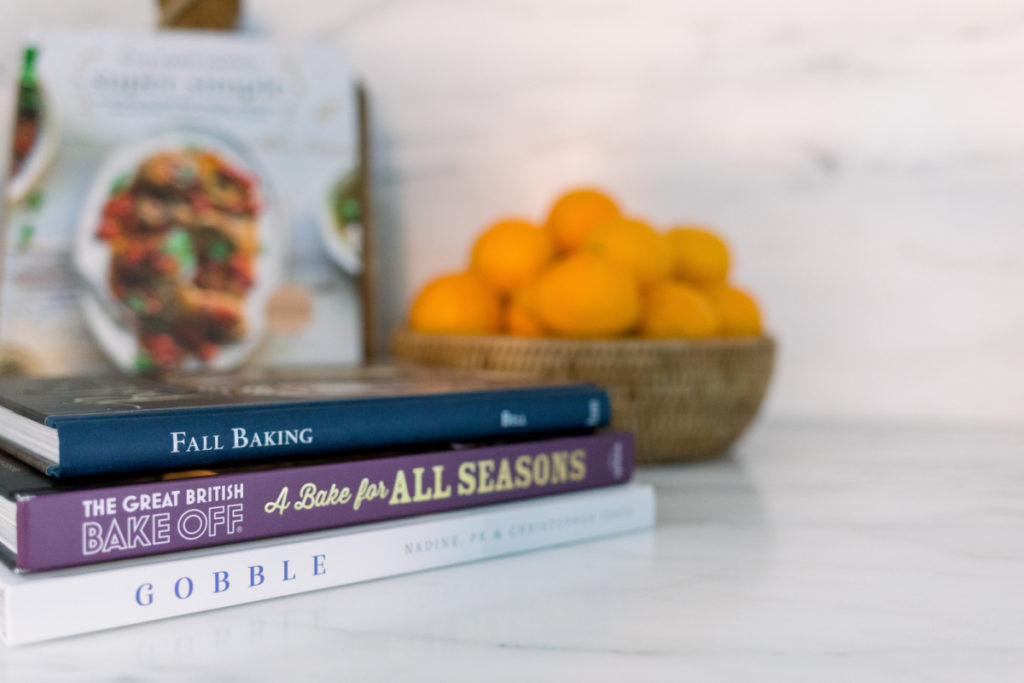 Cookbooks and bowl or oranges