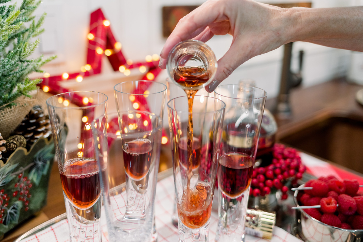 Pouring Chambord into champagne glasses