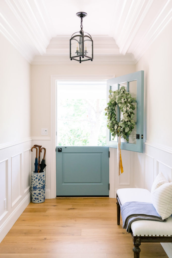 Small foyer with bench, umbrella stand and lantern.