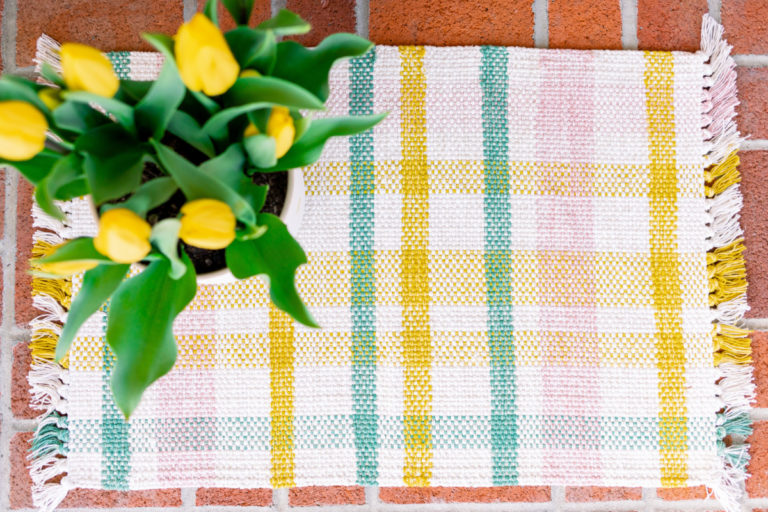 Spring doormat on tulips