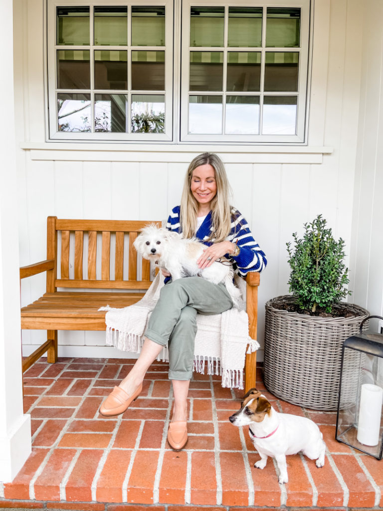 Woman and dogs sitting on outside bench