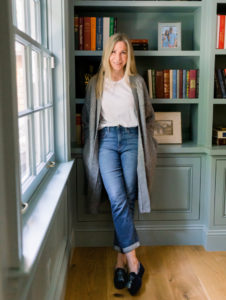 Woman leaning against bookshelf