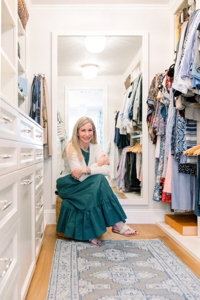 Woman sitting on stool in closet