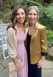 Two women at outdoor wedding reception