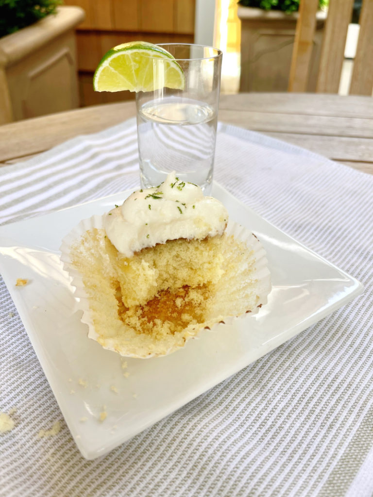 Bite out of a cupcake and tequila shot