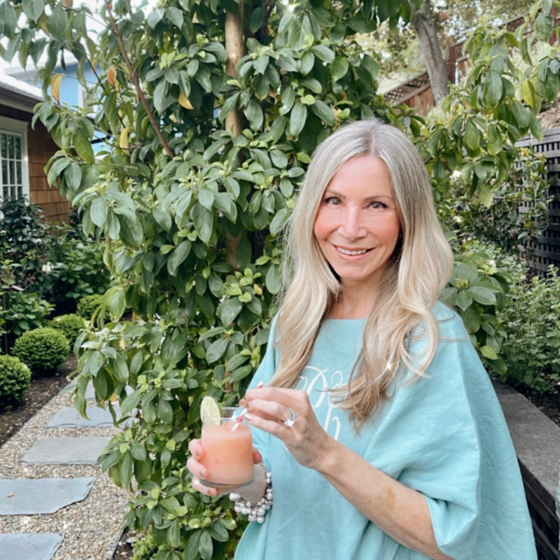 Woman in garden drinking frozen Paloma