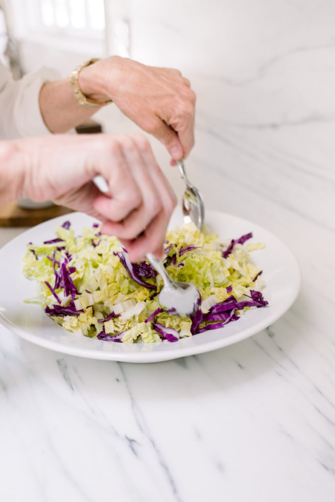 Tossing bowl of cabbage