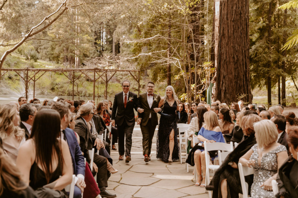 Groom and parents walking down aisle