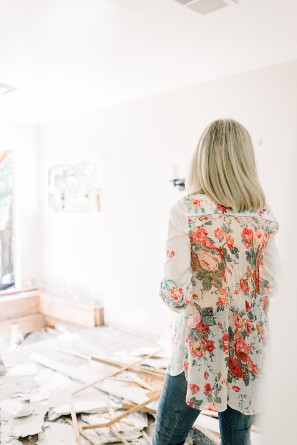 Woman standing in demo'd bathroom