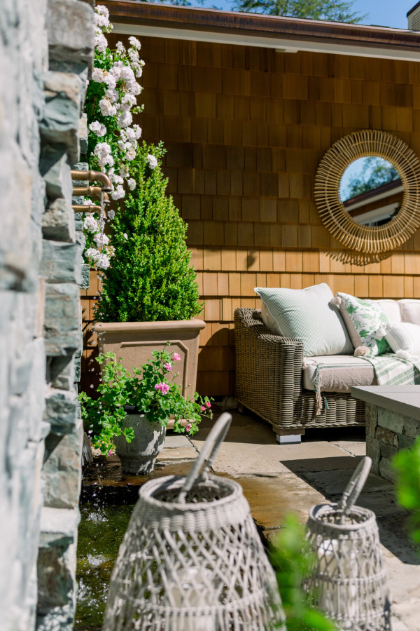 Beautiful backyard patio with boxwoods in pots