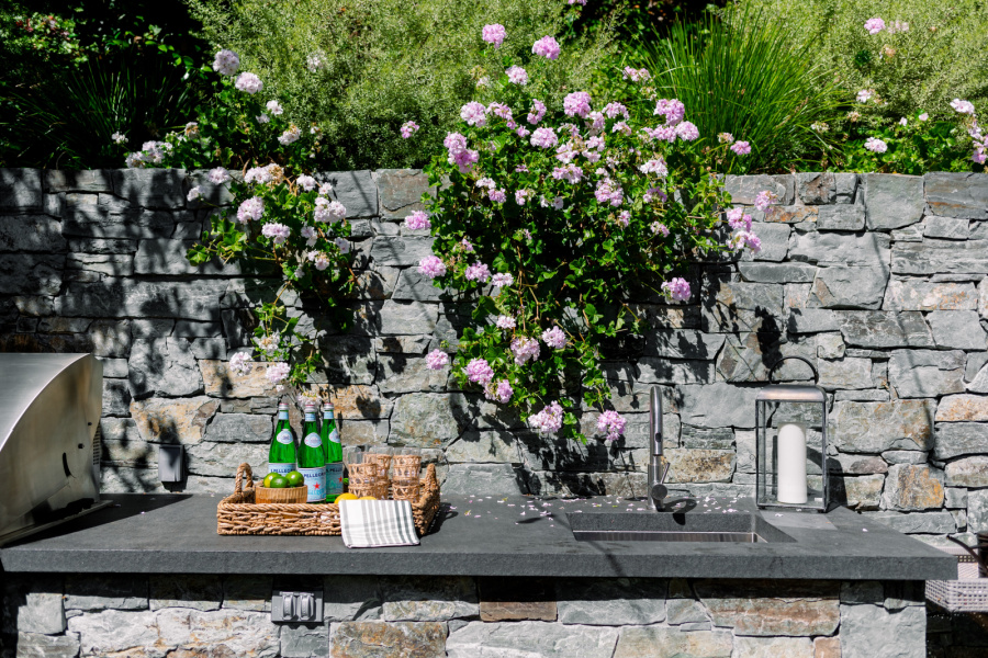 Outdoor kitchen sink and tray of glasses