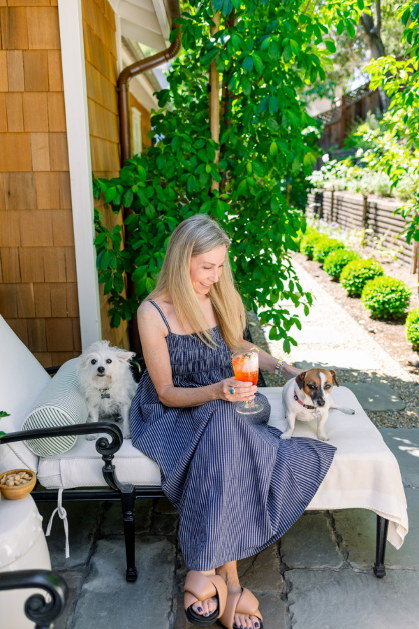Woman and dogs on patio chaise