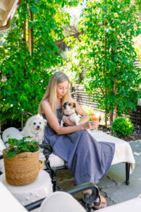 Woman and dogs on patio chaise