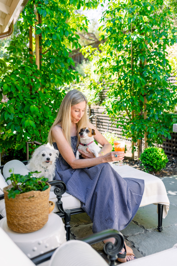 Woman and dogs on patio chaise