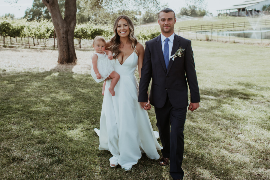 Couple and baby on wedding day