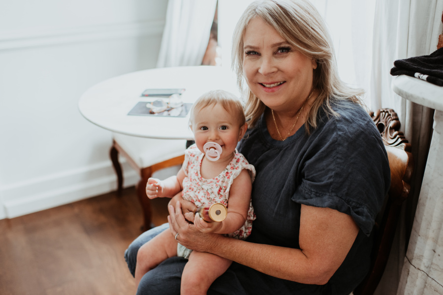 Grandma holding baby with pacifier