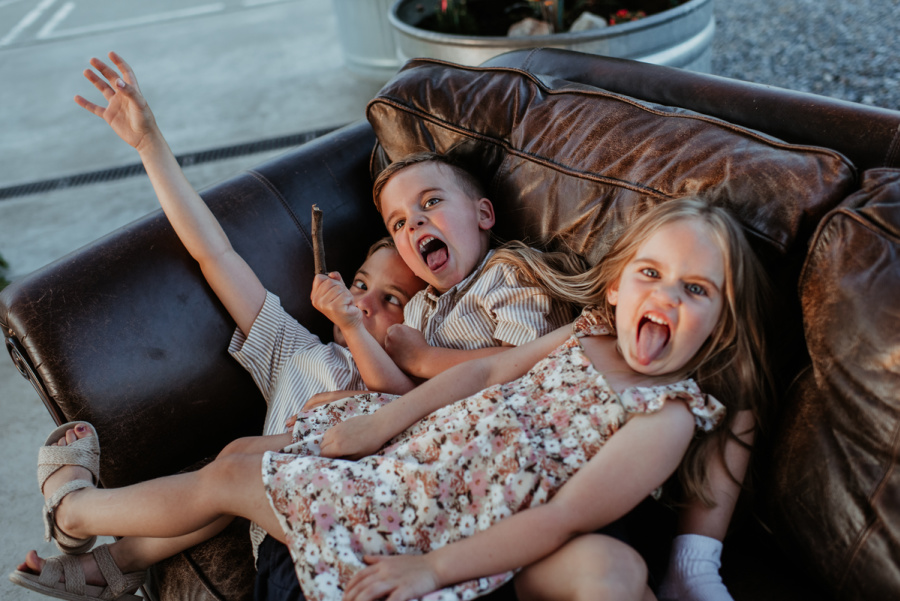 Three kids goofing around at the wedding