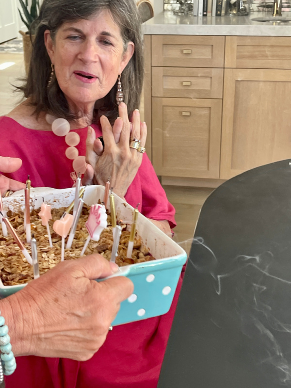 Woman blowing out her birthday candles