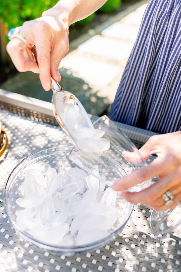 Adding scoop of ice to wine glass, Grapefruit Aperol Spritz