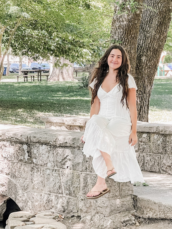 Woman sitting on bridge in park