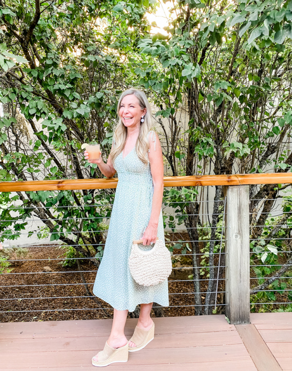 Woman standing on deck with cocktail