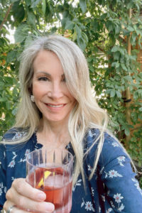 Woman in garden holding Dubonnet Cocktail.