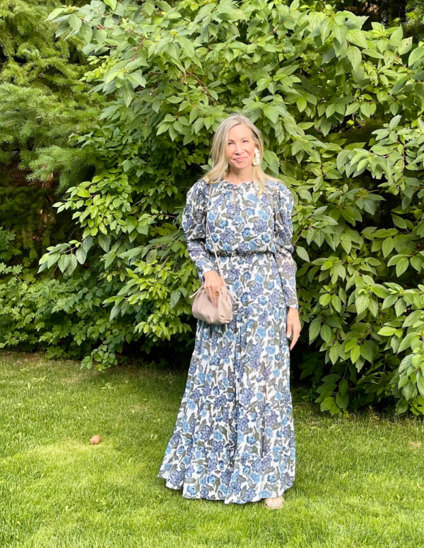 Woman standing in front of tree scape at wedding.